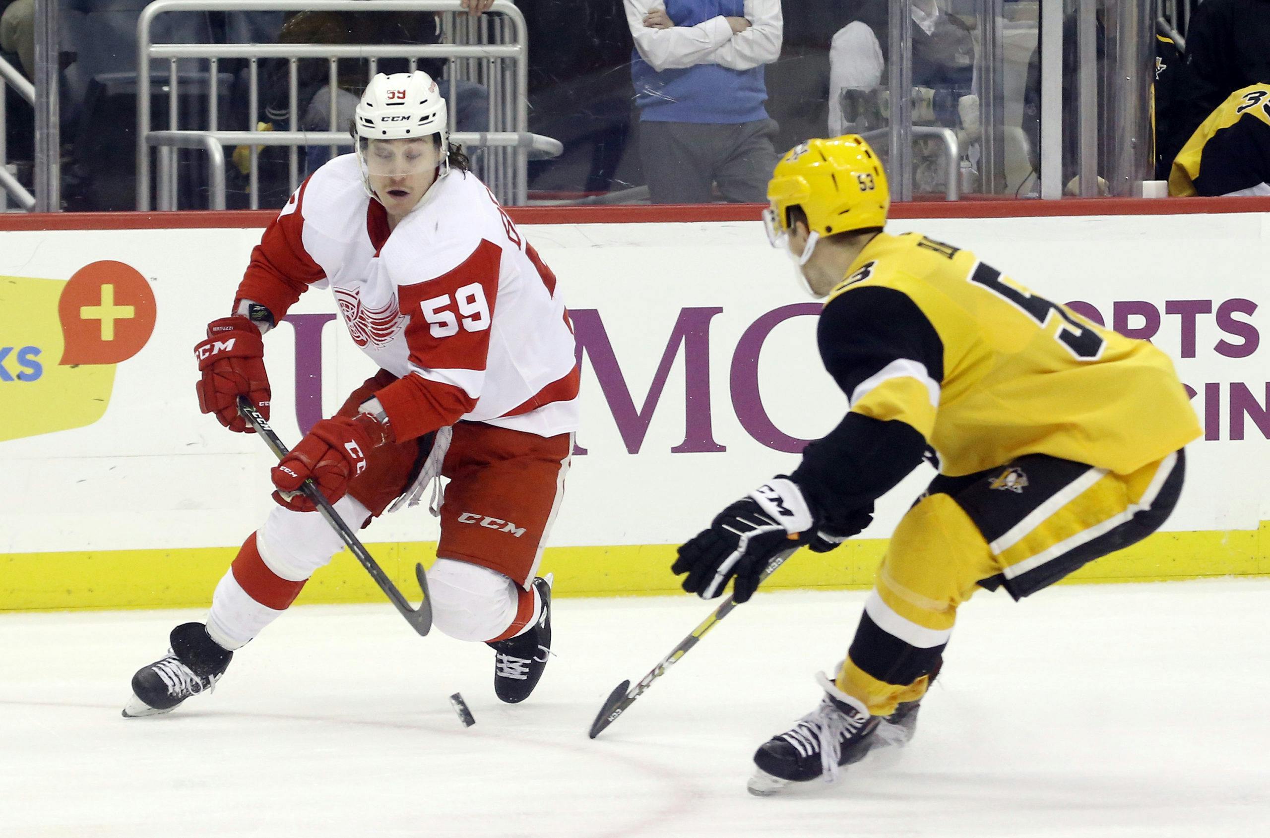 Detroit Red Wings left wing Tyler Bertuzzi (59) skates with the puck against Pittsburgh Penguins center Teddy Blueger (53) during the first period at PPG PAINTS Arena. Mandatory Credit: Charles LeClaire-USA TODAY Sports